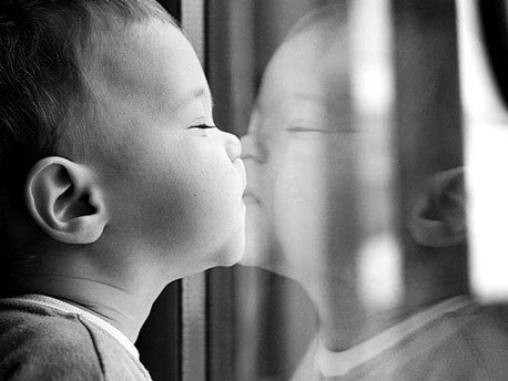 Baby kissing window