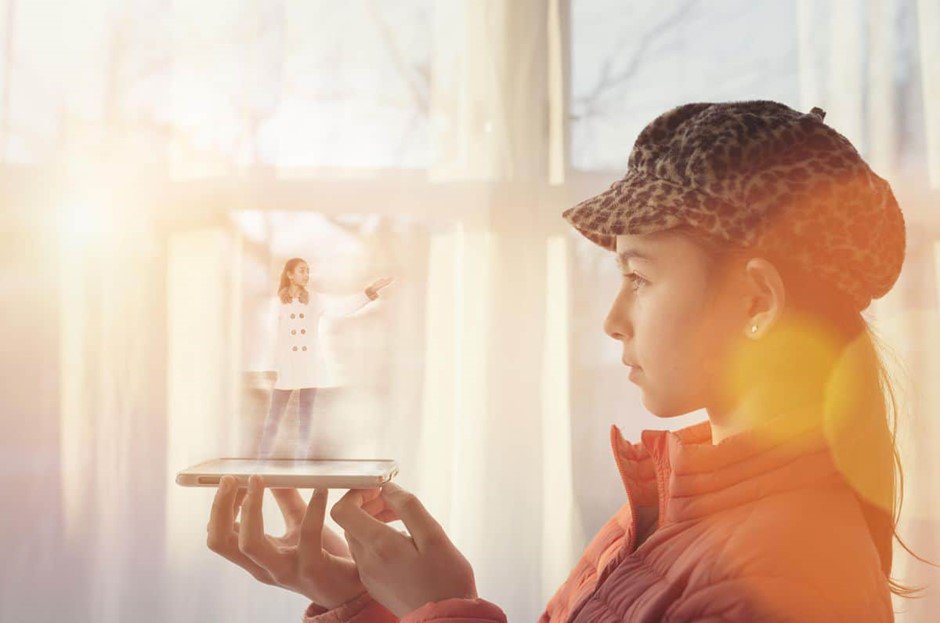 Girl with phone and hologram